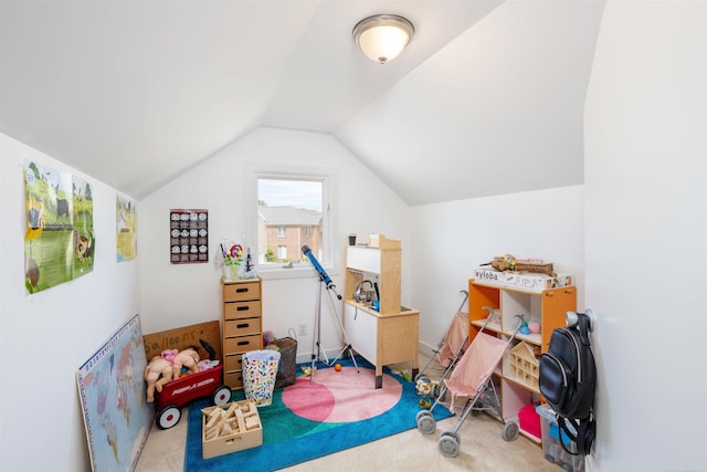 playroom with carpet floors and vaulted ceiling