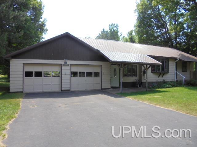 ranch-style home with a garage and a front yard