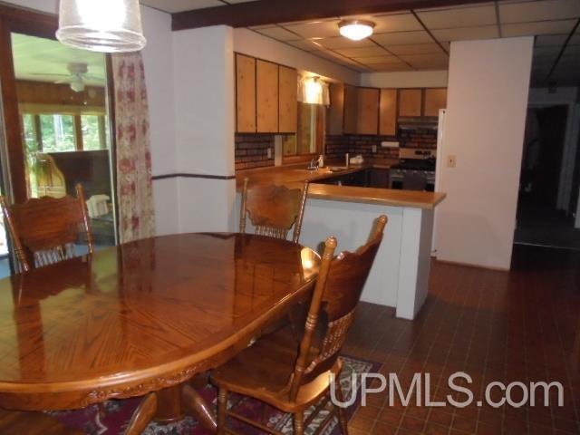 dining room featuring a drop ceiling and sink