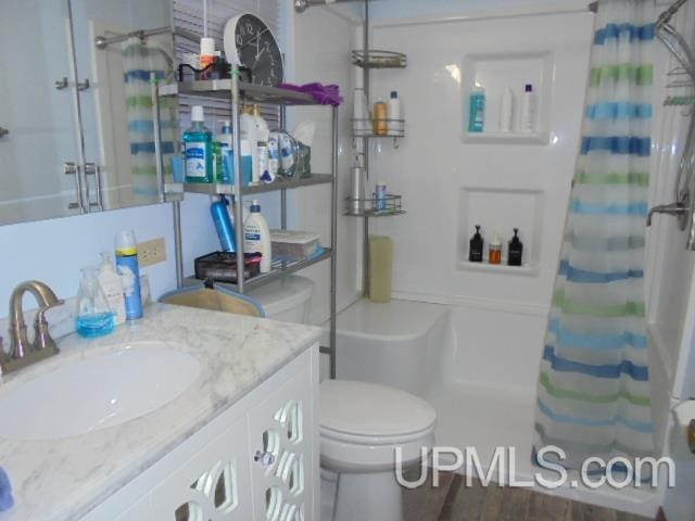 bathroom with a shower with curtain, vanity, toilet, and wood-type flooring