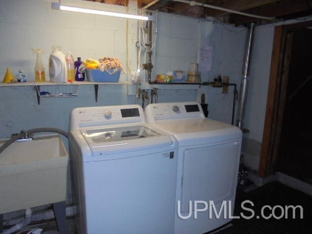 washroom featuring independent washer and dryer and sink