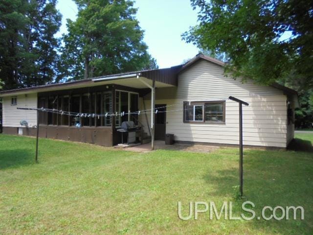 exterior space featuring a sunroom and a front lawn