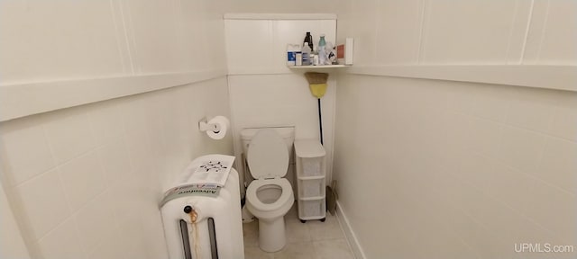 bathroom with radiator and tile patterned floors