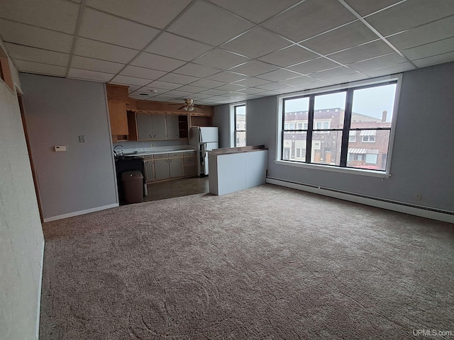 kitchen with light carpet, a baseboard radiator, fridge, and a paneled ceiling