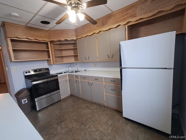 kitchen with sink, stainless steel electric range oven, white refrigerator, ceiling fan, and a drop ceiling