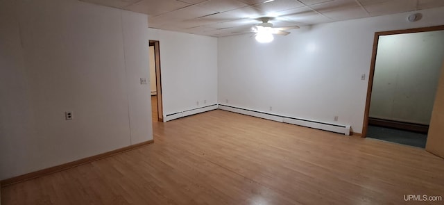 unfurnished room featuring a baseboard radiator, ceiling fan, and light wood-type flooring