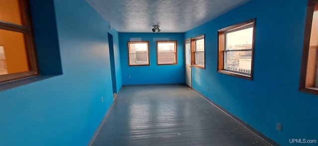 hallway with a textured ceiling