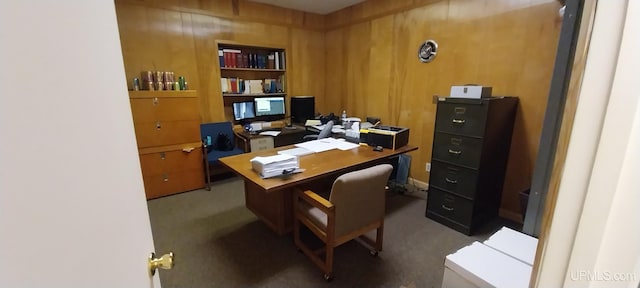 home office featuring carpet floors and wood walls