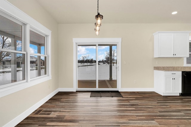 unfurnished dining area featuring dark wood-type flooring