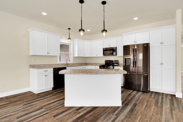 kitchen with a kitchen island, decorative light fixtures, white cabinets, and black appliances