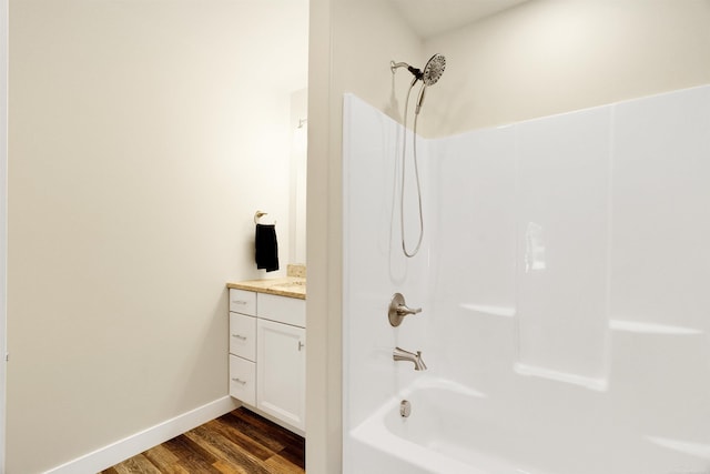 bathroom featuring vanity, hardwood / wood-style flooring, and shower / bathtub combination