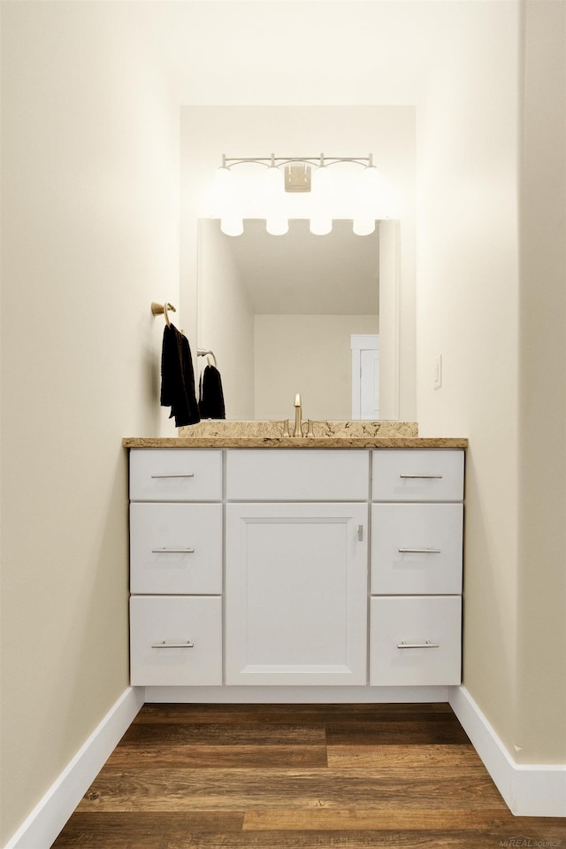 bathroom featuring hardwood / wood-style flooring and vanity