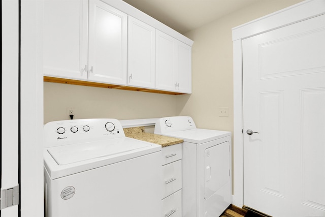 washroom with separate washer and dryer and cabinets