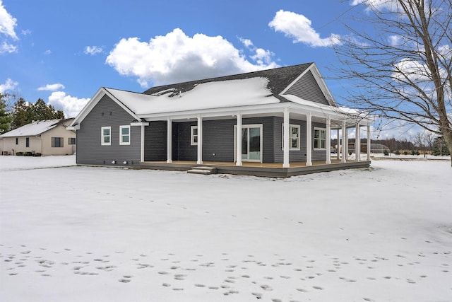 snow covered house with covered porch