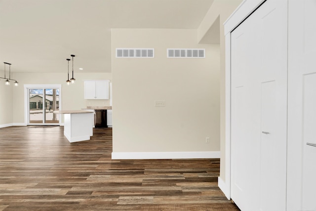 unfurnished living room featuring dark hardwood / wood-style floors