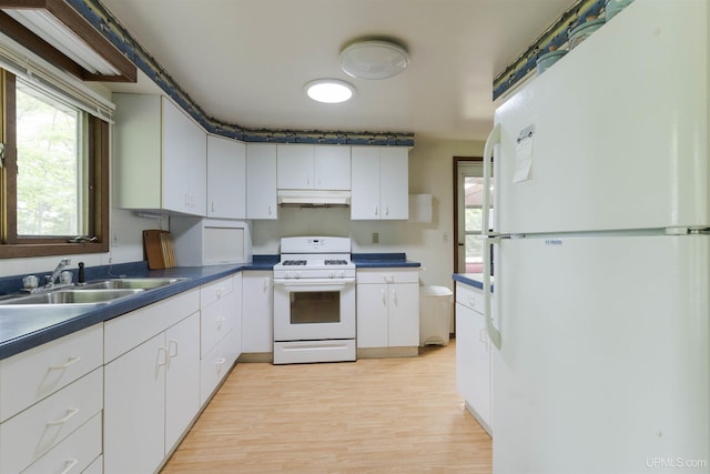 kitchen featuring sink, white appliances, white cabinetry, and light hardwood / wood-style floors