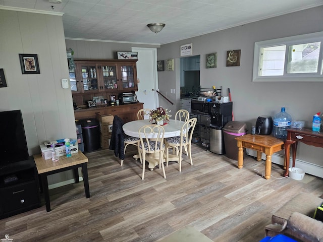 dining room featuring hardwood / wood-style flooring and crown molding