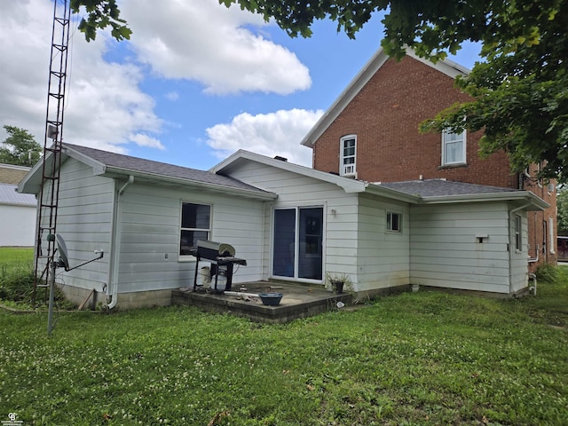 rear view of property featuring a lawn and a patio