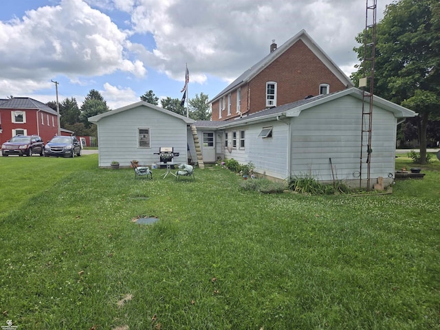 rear view of property featuring a yard