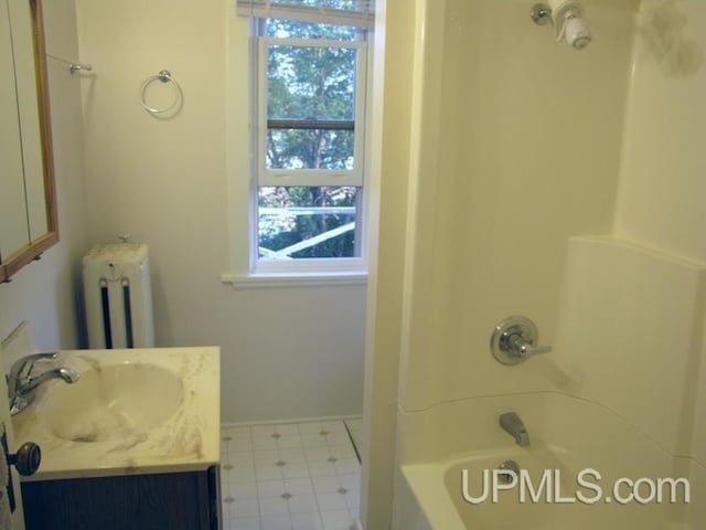 full bath featuring shower / washtub combination, radiator, vanity, and tile patterned floors