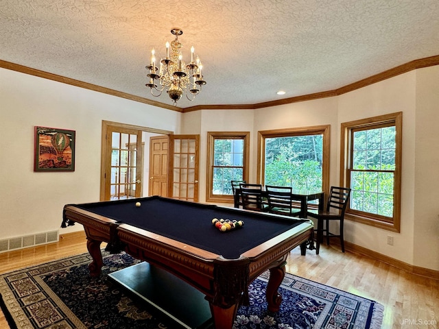 game room with visible vents, light wood-style flooring, baseboards, and ornamental molding