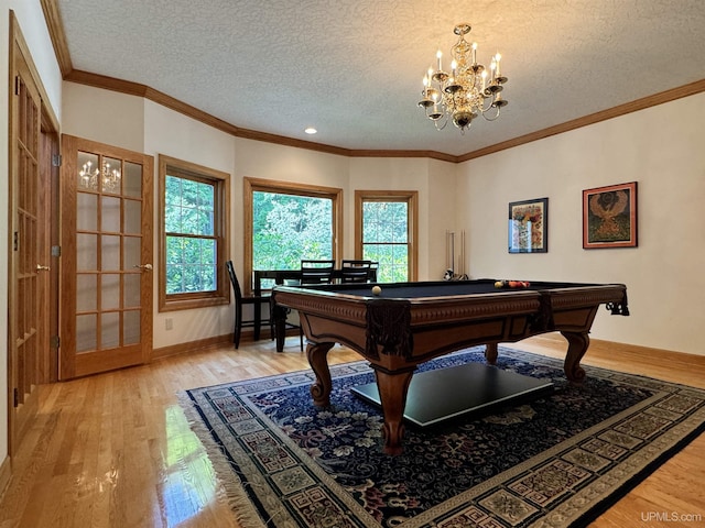 recreation room with billiards, light wood-style floors, crown molding, and a textured ceiling