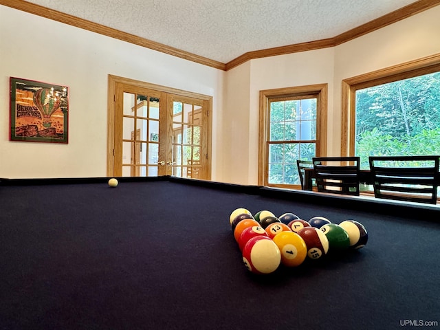 game room with billiards, french doors, a textured ceiling, crown molding, and carpet flooring