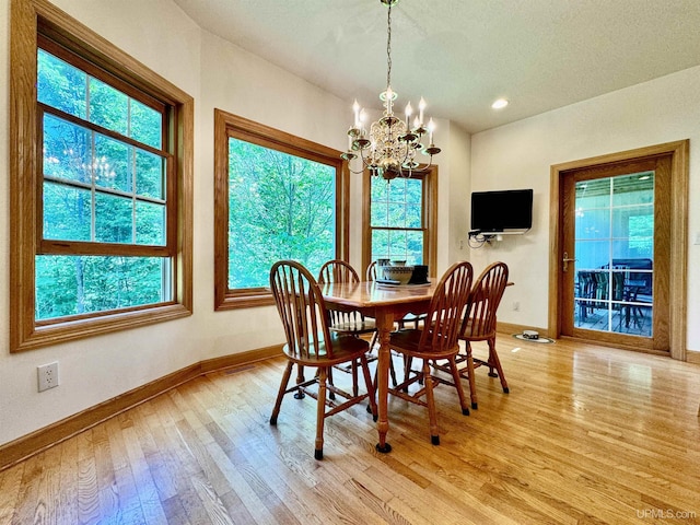 dining area featuring recessed lighting, baseboards, an inviting chandelier, and light wood finished floors