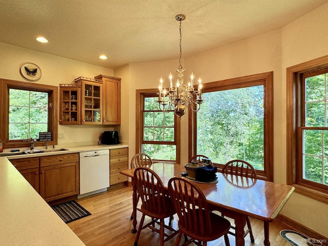 dining space with recessed lighting, light wood-type flooring, a wealth of natural light, and a chandelier