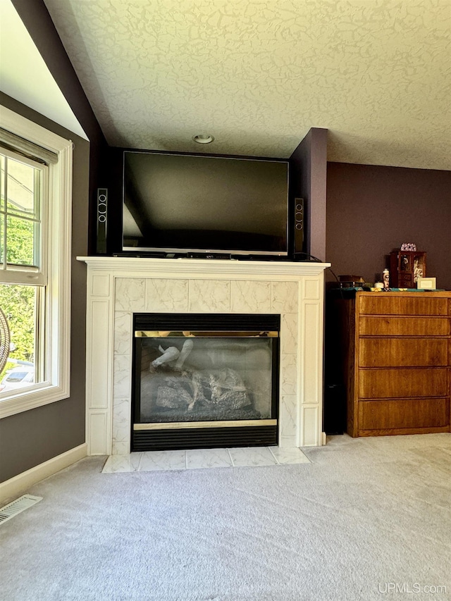 room details with carpet flooring, a fireplace, and visible vents