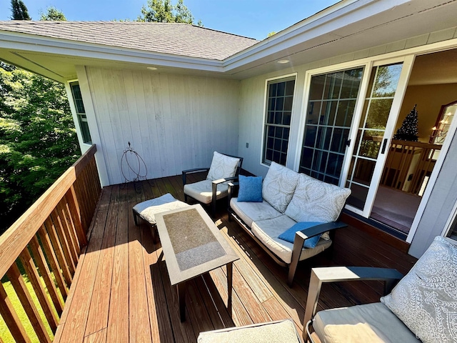 wooden terrace with an outdoor living space