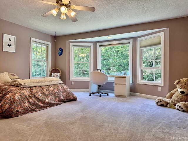 bedroom featuring baseboards, carpet, ceiling fan, and a textured ceiling