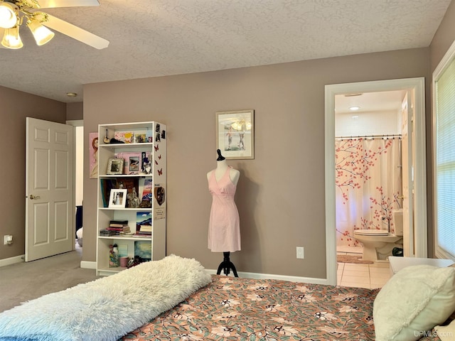 bedroom featuring connected bathroom, baseboards, a textured ceiling, and carpet floors