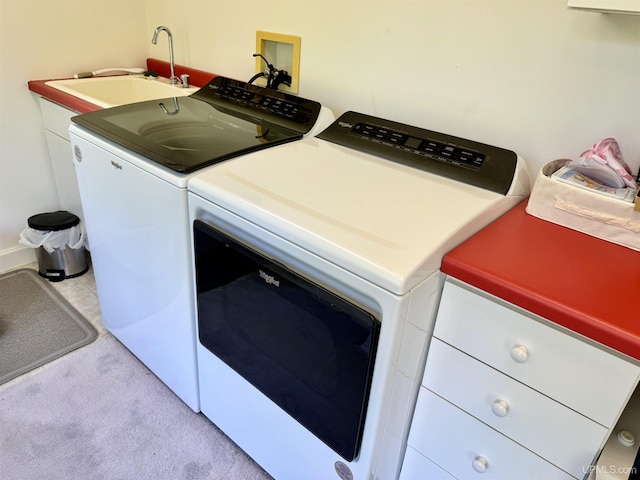 washroom featuring a sink, light carpet, laundry area, and washer and clothes dryer