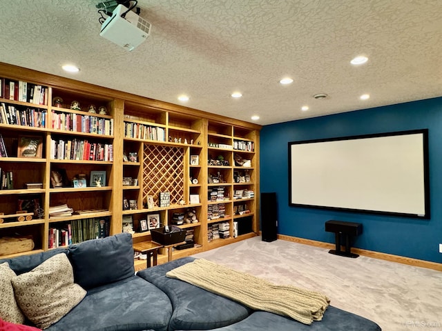 carpeted cinema room with recessed lighting, baseboards, and a textured ceiling