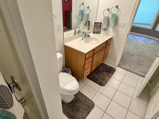 bathroom featuring tile patterned flooring, toilet, vanity, and baseboards