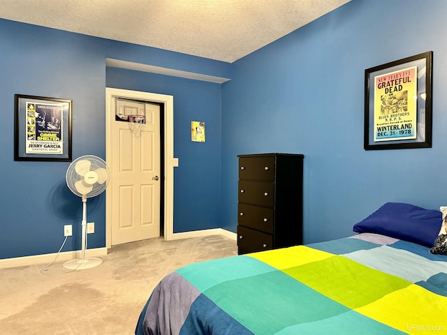 bedroom featuring baseboards, a textured ceiling, and carpet flooring