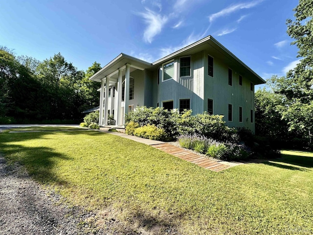 view of property exterior with a yard