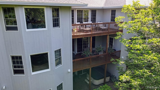 rear view of property with a shingled roof