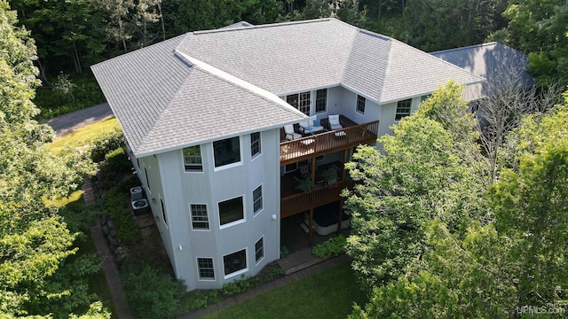 drone / aerial view with a wooded view