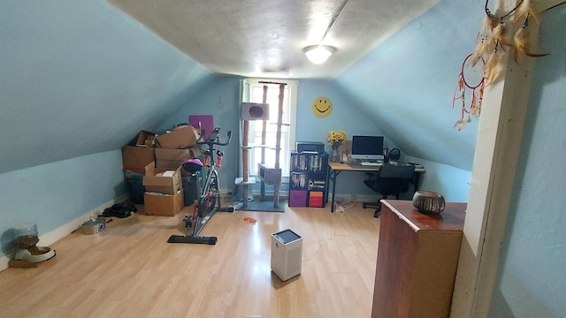 home office featuring lofted ceiling and light hardwood / wood-style floors