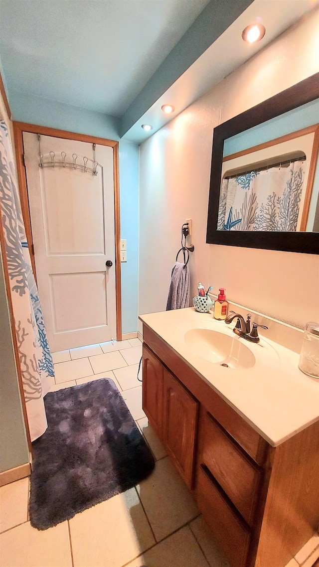 bathroom featuring tile patterned flooring and vanity