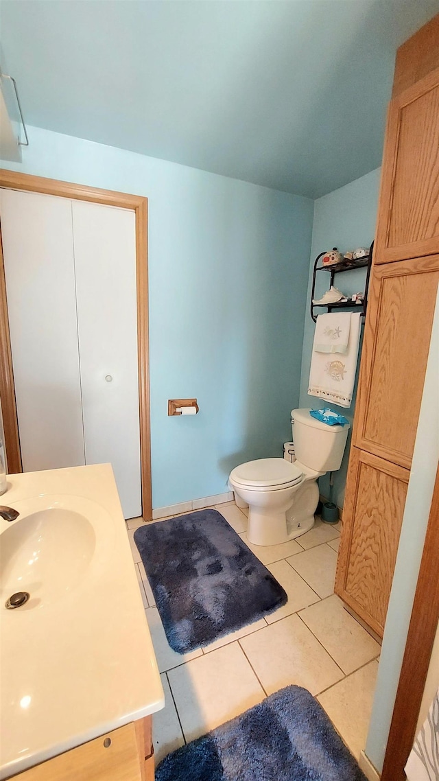 bathroom featuring tile patterned floors, toilet, and vanity