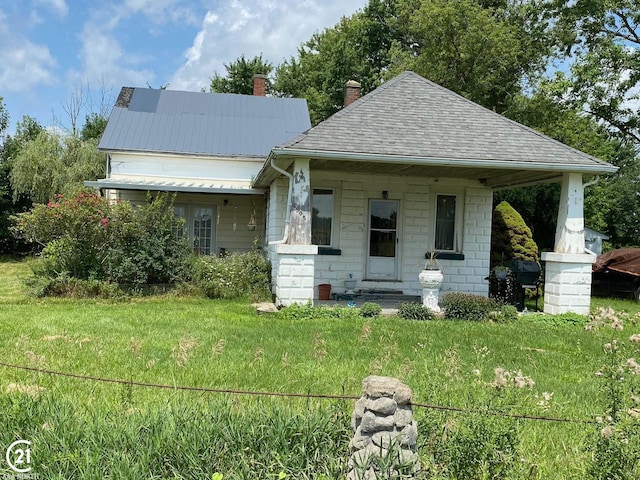 bungalow-style house featuring a front yard