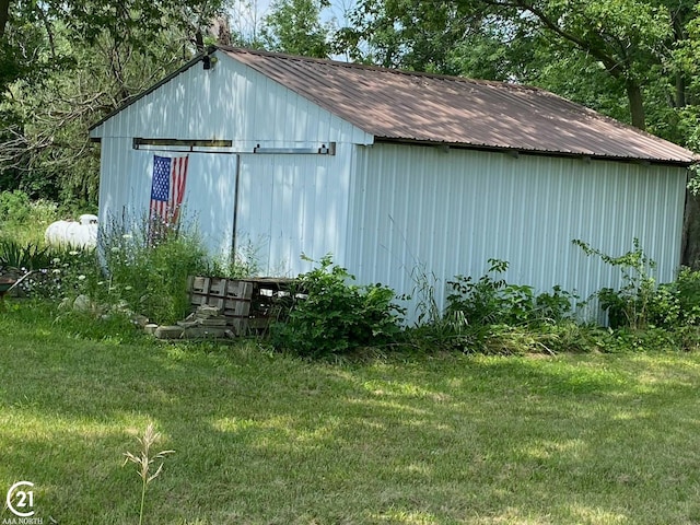 view of outbuilding featuring a lawn