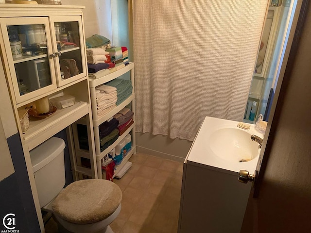 bathroom with tile patterned flooring, toilet, and vanity