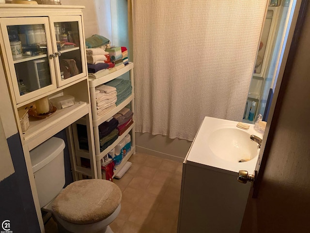 bathroom with tile patterned floors, toilet, and vanity