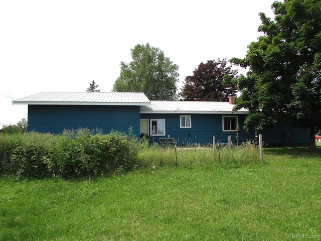 rear view of house featuring metal roof