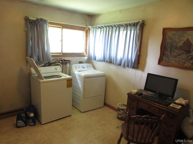 laundry room with laundry area, washing machine and dryer, and baseboards