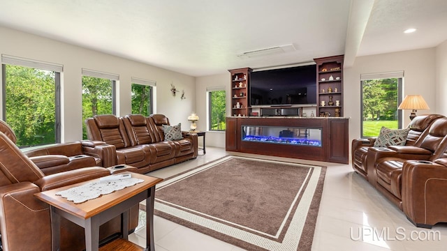 living room with light tile patterned flooring and plenty of natural light